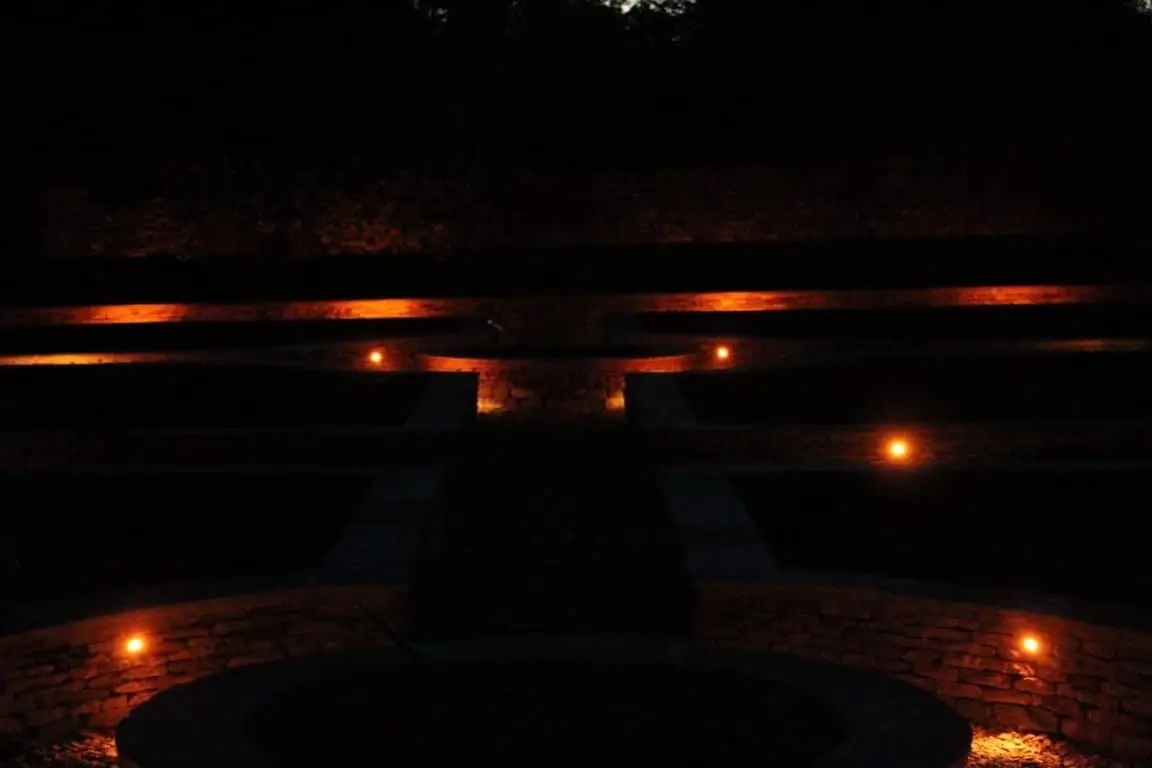 Detail of a copper-finish recessed light set into Cotswold stone